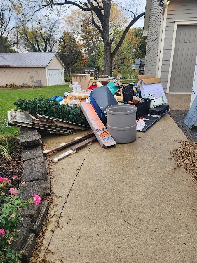 Dumpster being loaded with debris for 12 Yard Dumpster Rental in Leland